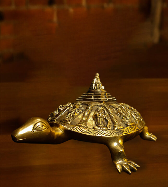 A handcrafted brass tortoise with Meru, a Vastu and Feng Shui decor piece available at Bharathiyam in Coimbatore.