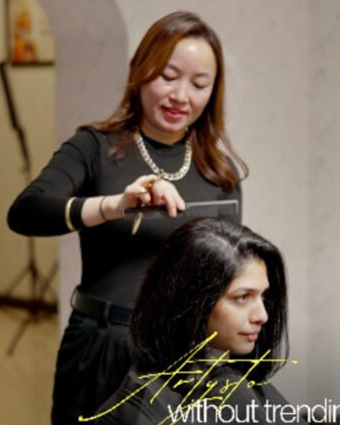 Expert stylist working on a client's hair at Artysto Salon, the best beauty salon near me in Coimbatore for ladies.