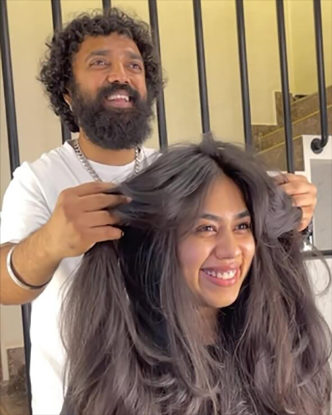 Expert stylist with a client showcasing long, healthy, voluminous hair at Artysto Salon, the best unisex parlour near me in Coimbatore.