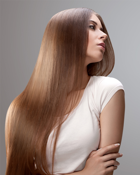 Woman showcasing the result of Artysto Salon Silk Protein Treatment: frizz-free, smooth, and luxuriously shiny hair.
